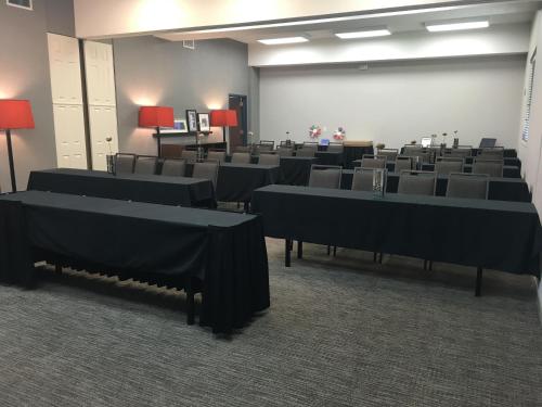a conference room with tables and chairs in it at Country Inn & Suites by Radisson, Austin North Pflugerville , TX in Round Rock