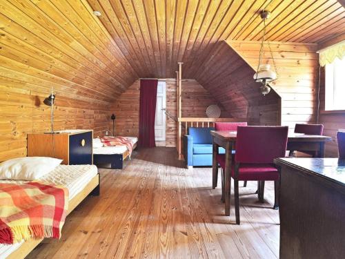 a bedroom with a bed and a table in a room at 8 person holiday home in LÖNSBODA-By Traum in Ubbaboda