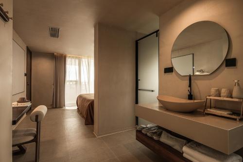 a bathroom with a sink and a mirror at DaLi牧云相框空间侘寂民宿 in Dali Ancient Town