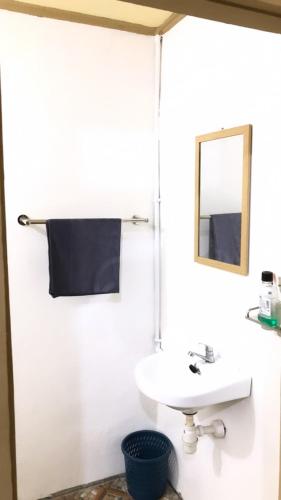 a bathroom with a sink and a mirror at Jenny's Bamboo Surf Camp in Karbang