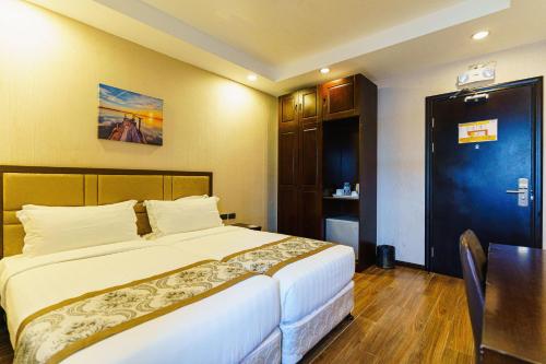 Postel nebo postele na pokoji v ubytování Palawan Uno Hotel