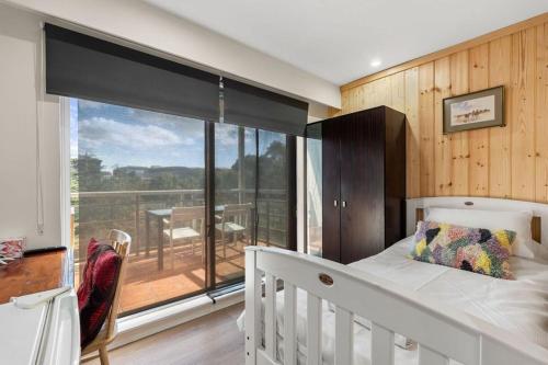 a bedroom with a bed and a large window at 72-1HS Abnb-Style GardenView, Parking, Balcony, Step to Chinatown and QVB in Sydney