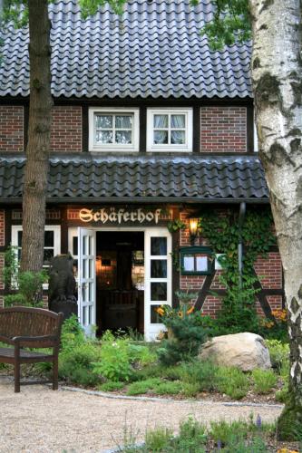 a building with a bench in front of it at Hotel Schäferhof in Schneverdingen