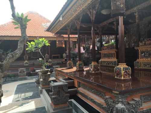 a building with potted plants on display in a building at Gedong Bali Family Homestay in Ubud