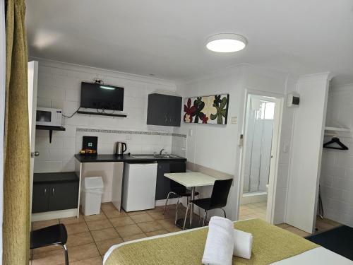 a small kitchen with a table and a counter at Cleveland Motor Inn in Cleveland