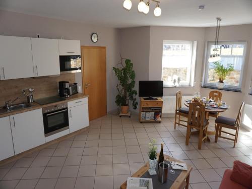 a kitchen and living room with a table and chairs at Vineyard View Romantic Stay in Kinheim