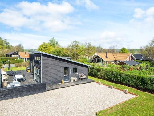 a modular home with a deck and a backyard at 6 person holiday home in Bjert-By Traum in Sønder Bjert