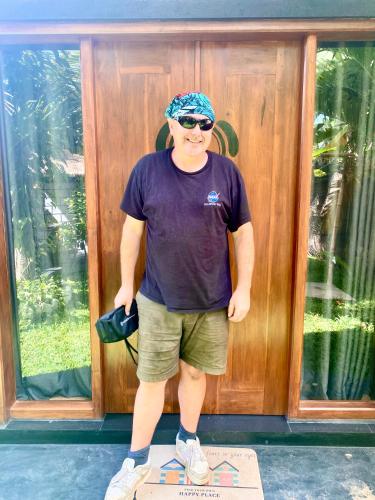 a man standing on a box in front of a door at Ritter Kreuz Cabana Resort in Tangalle