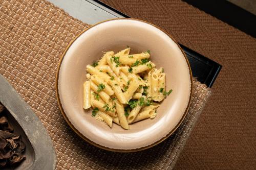 a bowl of pasta with parsley on a table at Kirindi Paddy Isle in Negombo