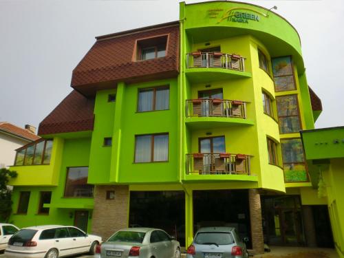 a green building with cars parked in front of it at Green Hisar Hotel Family in Hisarya
