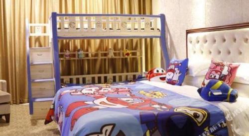 a bedroom with a bed with a mickey mouse bedspread at New Century Hotel Putuo Zhoushan in Zhoushan
