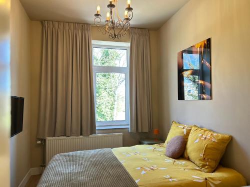 a bedroom with a bed in front of a window at Lovely Spacious Apartment in Zandvoort