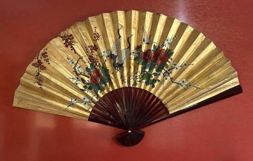 a fan hanging on a red wall at The Retreat at Froog Moore Park in Tamworth