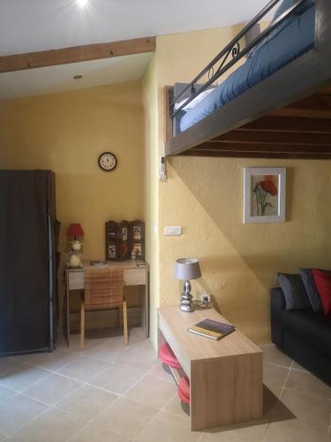 a living room with a loft bed and a desk at Tiny house in Avignon