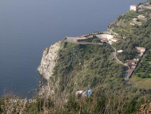 a road on the side of a mountain next to the water at B&B Centro Storico 900 in Palmi