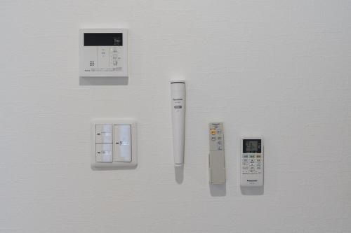 a group of remote controls on a wall at 楚々Soso in Miyazu