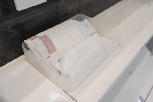 a white toilet with a roll of toilet paper in it at 楚々Soso in Miyazu