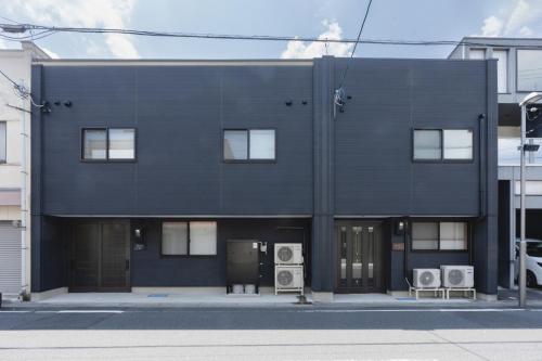 a black building with two speakers in front of it at 楚々Soso in Miyazu