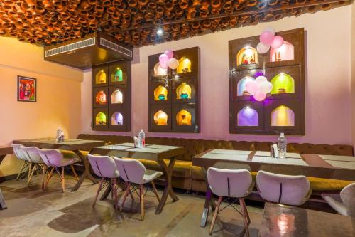 a restaurant with tables and chairs in a room at Stamps Golden Lagoon by Eight Continents - Opposite to Golden Temple in Amritsar