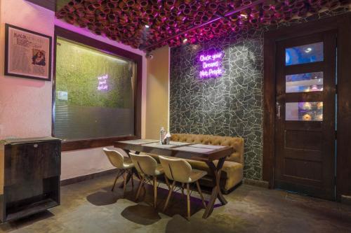 a dining room with a table and chairs and a window at Stamps Golden Lagoon by Eight Continents - Opposite to Golden Temple in Amritsar