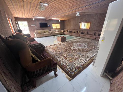 an overhead view of a living room with couches and a rug at Maeen Rest House in Ma‘mad
