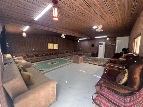 a large living room with couches and a pool at Maeen Rest House in Ma‘mad