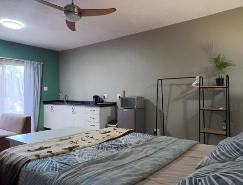a bedroom with a bed and a ceiling fan at Shaka's Rest Studio One in Mount Moreland