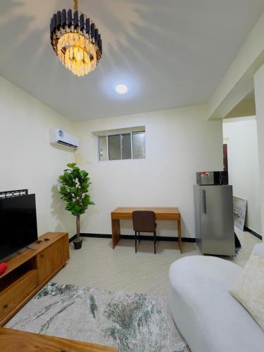 a living room with a couch and a table at Sinza Hiddenout in Dar es Salaam