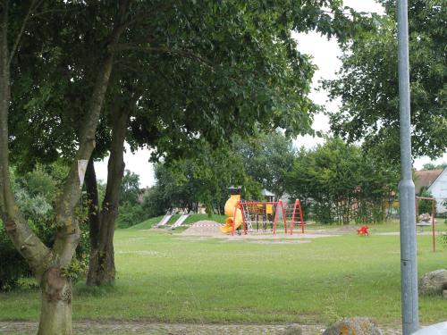 a park with a playground with a slide at Gutshaus in Gressow mit Teich in Gressow