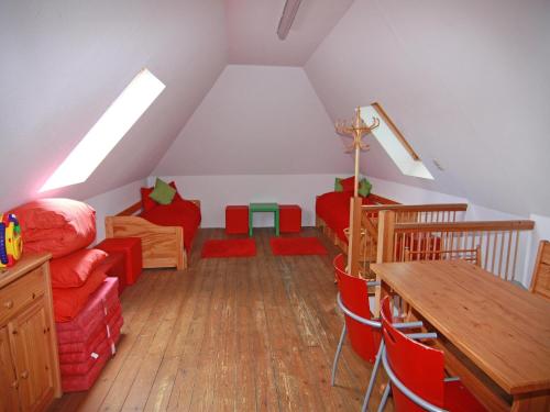 a attic room with a couch and a table at Gutshaus in Gressow mit Teich in Gressow