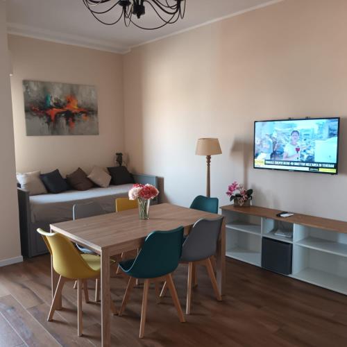 a living room with a table and chairs and a couch at Appartamento Centrale Ladispoli in Ladispoli