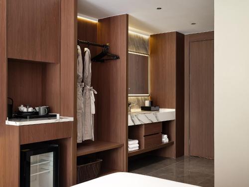 a bathroom with wooden walls and a sink and a mirror at Zhangjiajie SANHE Hotel --Free one way pick up service over 2 night, Free shuttle to east gate of forest park,Free laundry service,Free fresh coffee,English speaking customer service in Zhangjiajie