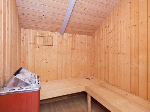 a inside of a wooden sauna with a trash can at Cozy Retreat with Spa - By Traum Ferienwohnungen in Sarup