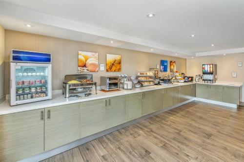 a large kitchen with a counter in a restaurant at Comfort Inn in Chatham