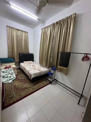a bedroom with a bed and a window with curtains at MITC Comfort Stay in Malacca