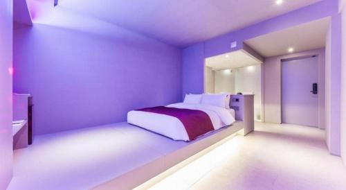 a bedroom with a bed in a purple room at Bobo Hotel Hongdae in Seoul