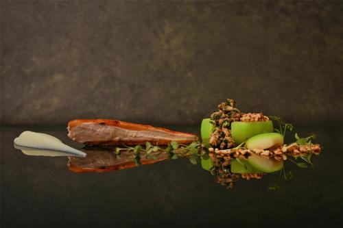 a piece of food with fruit and nuts on it at Kempinski Hotel San Lawrenz in San Lawrenz