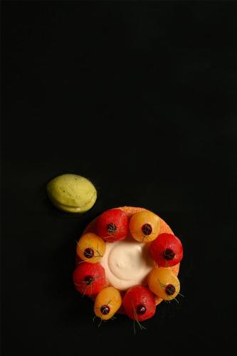 a group of fruit on a black surface with a face at Kempinski Hotel San Lawrenz in San Lawrenz