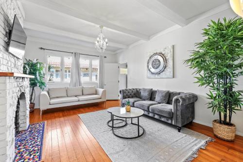 a living room with a couch and a table at Central Epsom Retreat in Auckland