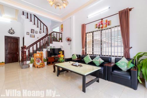 a living room with a couch and a table at Biệt Thự Hồ Bơi Nguyên Căn Free Sub Và Xe Máy in Vung Tau