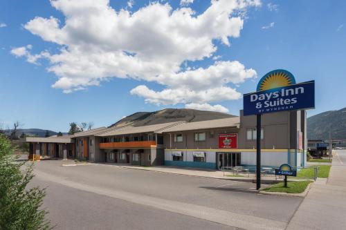 a days inn and suites sign in front of a building at Days Inn and Suites by Wyndham Downtown Missoula-University in Missoula
