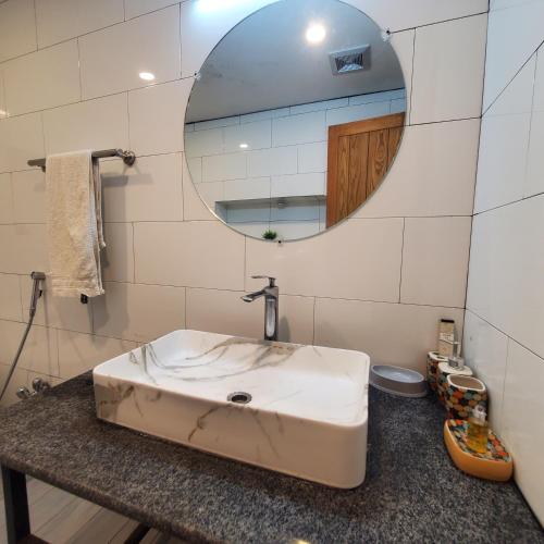 a bathroom with a white sink and a mirror at Private Suite with Private Entrance - Self Check in - F-8 - Private Parking in Islamabad