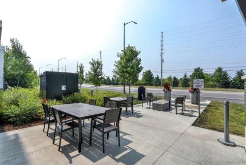 a patio with tables and chairs on the side of a road at Microtel Inn & Suites by Wyndham Kanata Ottawa West in Kanata