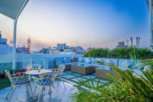 a patio with a table and chairs on a roof at Stamps Golden Lagoon by Eight Continents - Opposite to Golden Temple in Amritsar
