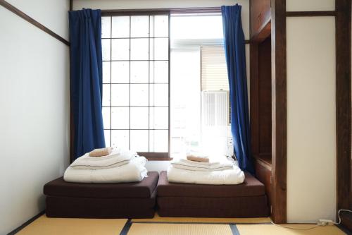 a room with two bean bags in front of a window at Sansan Yuzawa Backpackers in Yuzawa