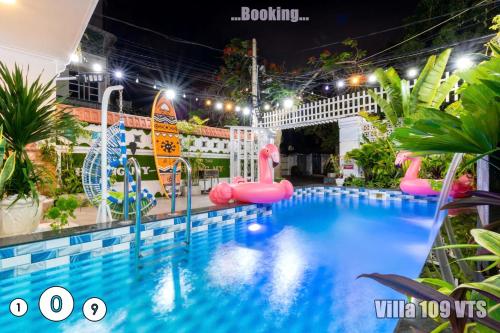a pool at night with pink flamingos and a water park at HM Villa Bãi Sau Lô Góc Nhiều tiện ích GIẢI TRÍ in Vung Tau