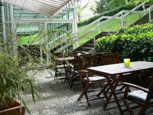 a patio with a table and chairs and stairs at Hotel Carolinenhof in Berlin
