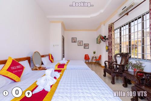 a bedroom with two beds and a large window at HM Villa Bãi Sau Lô Góc Nhiều tiện ích GIẢI TRÍ in Vung Tau