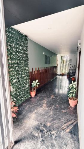 a hallway with potted plants in a building at Nelleri Residency Managed By Vaishno Hospitality in Iritti