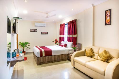 a hotel room with a bed and a couch at Octave Hotel and Spa - JP Nagar in Bangalore